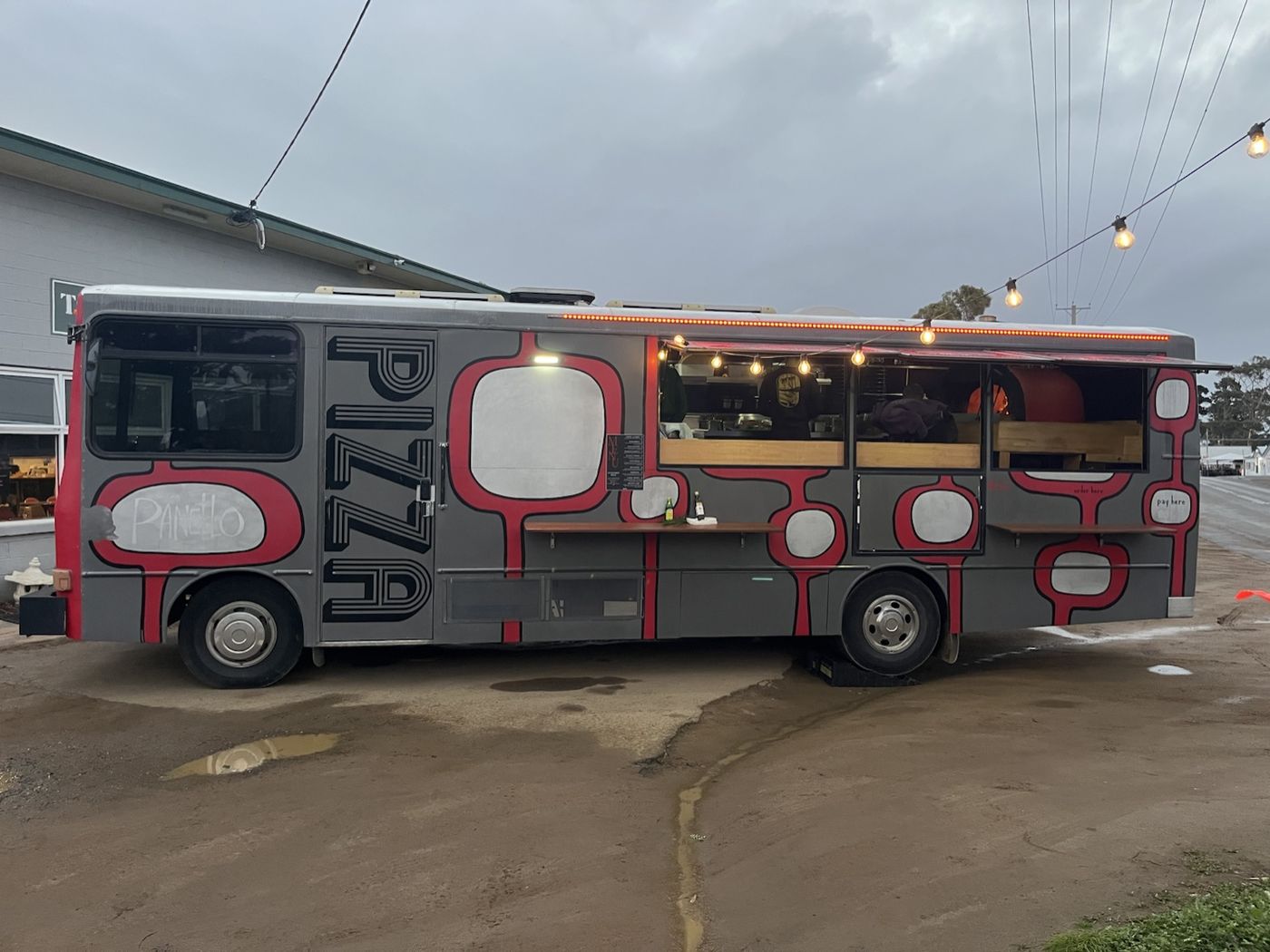 The red and grey Ember Bus pizza bus